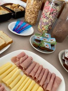 a table with plates of different types of food at Hotel Arenas Blancas in Federación