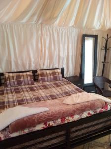 a bed in a room with a white tent at Luner Camp at Wadi Rum in Wadi Rum