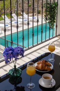 a table with a plate of food and two glasses of orange juice at Villa Mirta in Bol