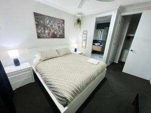 um quarto branco com uma cama num quarto em Plantation Retreat 4 Bedroom Modern Home em Landsborough