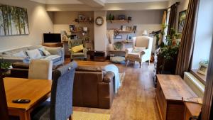 a living room with a couch and a table at Cadshaw Country Views in Darwen