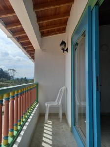 a chair on the balcony of a house at vista piedra in Guatapé