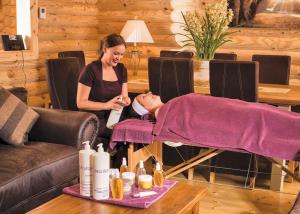 a woman standing next to a woman laying on a table at Sun Hill Lodges in Constable Burton