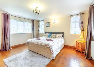 a bedroom with a bed and two windows at Camper Uk Leisure Park in Doddington