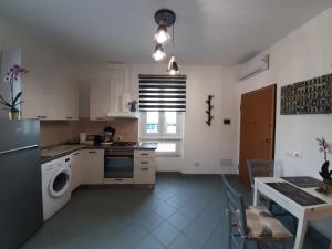 a kitchen with a sink and a dishwasher in it at Vinessa Home in Peschiera del Garda