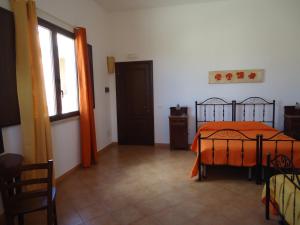 A bed or beds in a room at Baglio Messina Vacanze