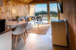 a living room with a table and a couch at Cabañas Rias Baixas in A Pobra do Caramiñal
