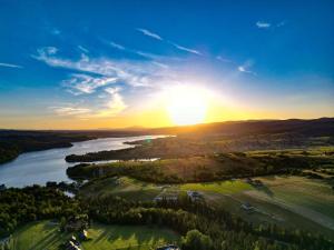 an aerial view of a river with the sun setting at Eco Active Resort PIENINY in Czorsztyn