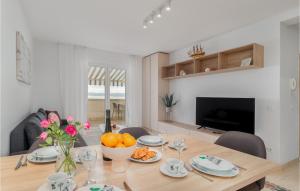 a dining room table with a bowl of oranges on it at Amazing Apartment In Selce With House Sea View in Selce