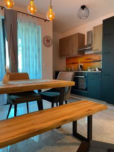 a kitchen with a wooden table and some chairs at Apartment Sandy Beach - 1st row at sea in Pješčana Uvala 