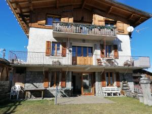 an apartment building with a balcony and a patio at chalet Mont-Blanc in Combloux