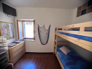 a bedroom with two bunk beds and a desk at Casa Alba in Monterosso al Mare