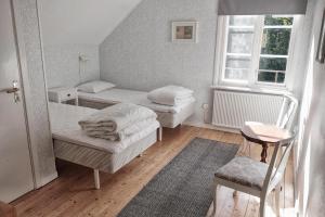 a small room with two beds and a window at Stocklycke Omberg in Omberg