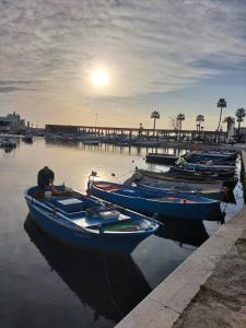 a group of boats docked in the water near a pier at PORTO 48 in Bari