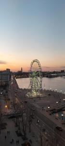 a ferris wheel in a city at sunset at PORTO 48 in Bari