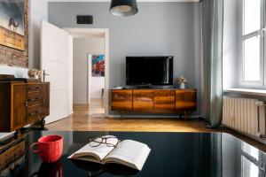 TV a/nebo společenská místnost v ubytování Apartament Roxy Q4Apartments