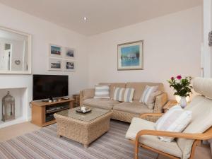 a living room with a couch and a tv at Snugglers Cove Apt 2 in Dartmouth