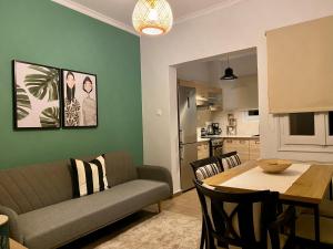 a living room with a couch and a table at Oasis Garden Apartment in Volos