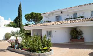 a white house with plants in front of it at Marbella Villa Sea View 10 Bedrooms in Estepona