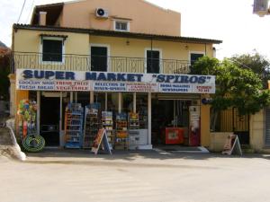 a store with a sign that reads super market supplies at Apartments Mary in Agios Gordios