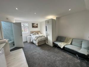 a living room with a couch and a bed in it at Regent Luxury Studio in Coventry