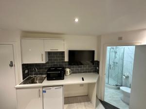 a small kitchen with a sink and a microwave at Regent Luxury Studio in Coventry