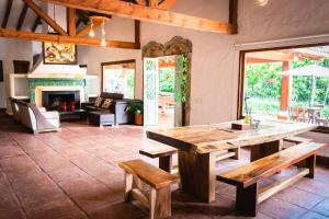 a living room with a table and a fireplace at Finca La Hacienda in El Retiro