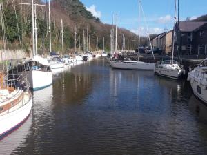 a group of boats are docked in a marina at 1 Dinas cottages in Caernarfon +7 photos