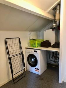 a laundry room with a washing machine and a shelf at Cramer's Corner in Hardenberg