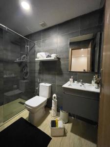 a bathroom with a toilet and a sink and a shower at Résidence du parc in Mohammedia