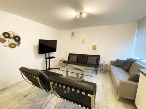 a living room with a couch and a tv at FeWo Sonnenlay - Apartments an der Mosel in Brauneberg