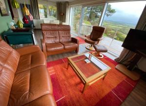 a living room with a couch and chairs and a table at Westwood - The B&B with a view in Cockermouth