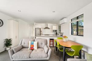 a living room with a couch and a table at Relax on Snowberry - Wanaka Holiday Home in Wanaka
