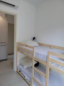 מיטה או מיטות קומותיים בחדר ב-Ailleurs Land