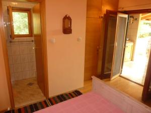 a bathroom with a shower and a glass door at Studio Orange in Zavala
