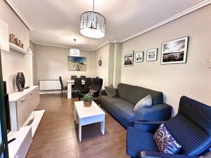 a living room with a couch and a table at Villa Mercedes - 17001 in Santoña