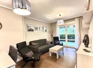 a living room with a couch and a table at Villa Mercedes - 17001 in Santoña