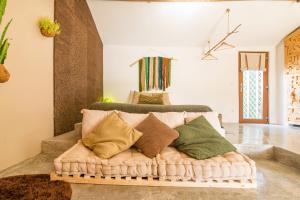 a couch with pillows on it in a room at Obidos Rural Chic House in Usseira