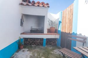 a patio with a fireplace in a house at Obidos Rural Chic House in Usseira