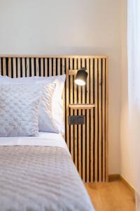 a bedroom with a bed with a wooden headboard at Hygge Rooms Split in Split