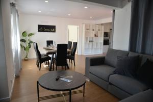 a living room with a couch and a table and chairs at Marvão Serra & Mar in Seia