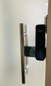a cell phone is attached to a refrigerator at NOVO APARTAMENTO Liz 1 in Porto Seguro