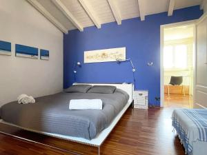 カターニアにあるSCS Modern luxury penthouse URGの青い壁のベッドルーム1室(大型ベッド1台付)