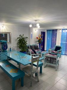 sala de estar con mesa azul y sillas en CHALET SANTORINI, en Calima