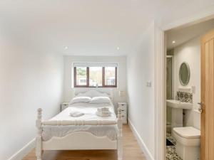 a white bedroom with a bed and a bathroom at Stunning Three Bed Cottage - Cottage 3 in Doncaster