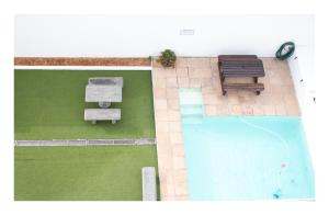 an overhead view of a swimming pool with two benches at St Clouds Strand in Strand