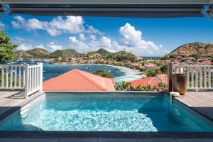 a swimming pool with a view of the water at Villa Rackam in Terre-de-Haut