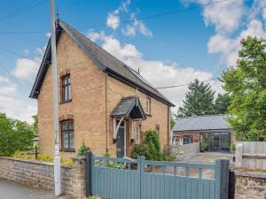 a brick house with a fence in front of it at Forge in Newbridge on Wye