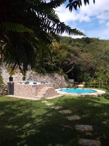 two swimming pools in a yard with a hill at Cabaña la palma in Copacabana