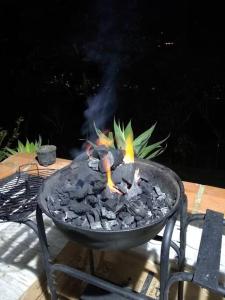 a grill with fire in it on a patio at Cabaña la palma in Copacabana